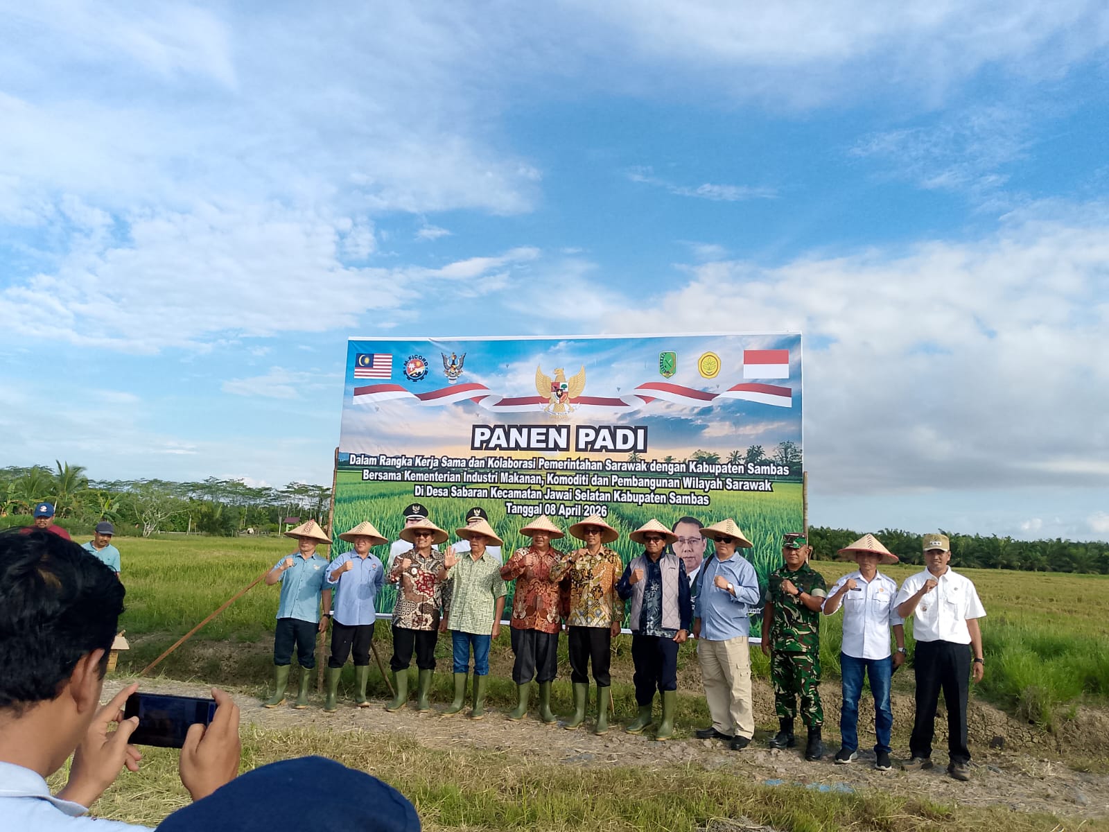 Pasi Log Kodim 1208/Sambas Ikuti Panen Padi Dalam Rangka Hanpangan dan Kerja Sama Pemerintah Sarawak dan Kabupaten Sambas